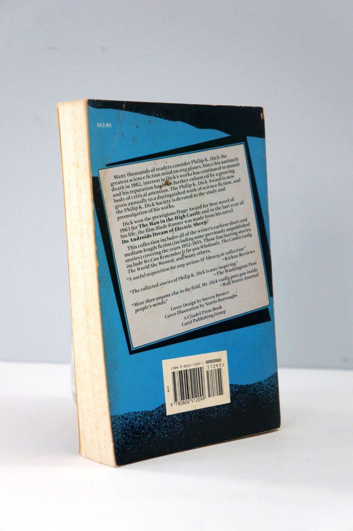 Book with blue and black cover on a white surface