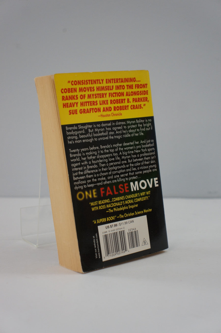 Back cover of a book titled 'One False Move' with text and a yellow label on a white background.
