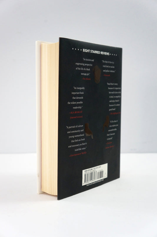 Book with a black cover and beige pages on a white background