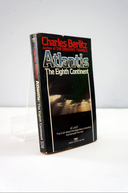 Book titled 'Atlantis: The Eighth Continent' by Charles Berlitz on a white background