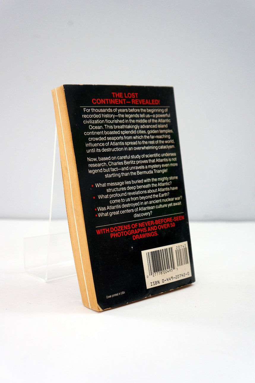 Back cover of a book with text and a barcode on a white background