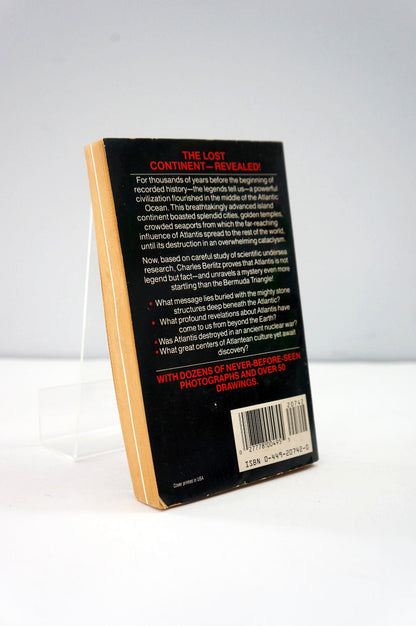 Back cover of a book with text and a barcode on a white background