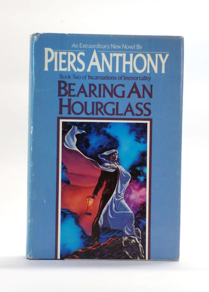 A vintage hardcover book of Piers Anthony's novel 'Bearing an Hourglass' on a white background.