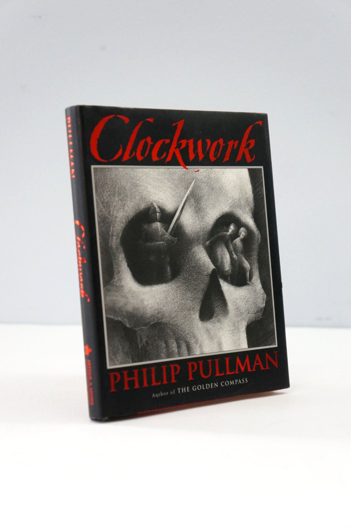 Book titled 'Clockwork' by Philip Pullman with a black and white illustration on the cover.