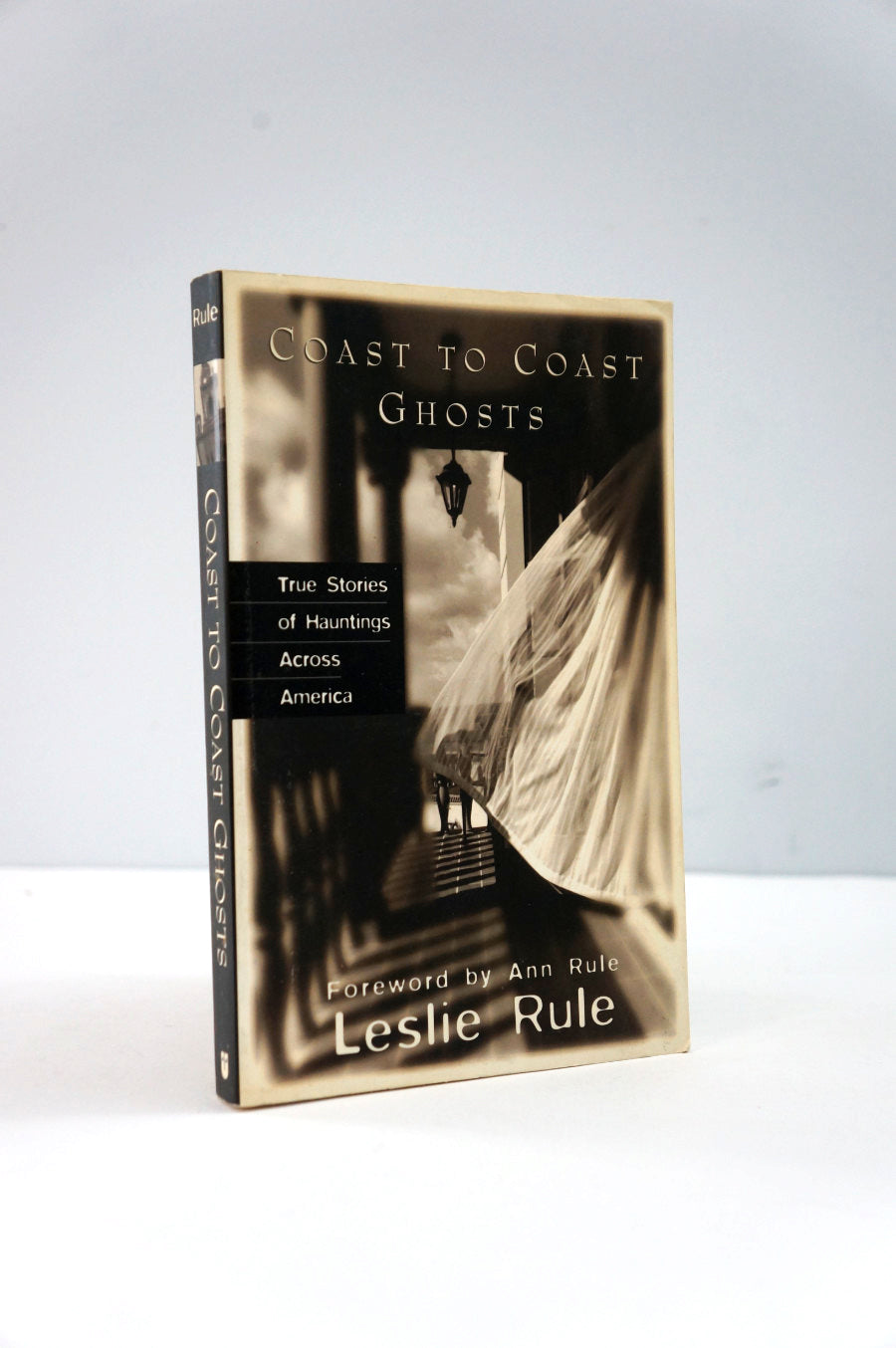 Book titled 'Coast to Coast Ghosts' by Leslie Rule on a white background