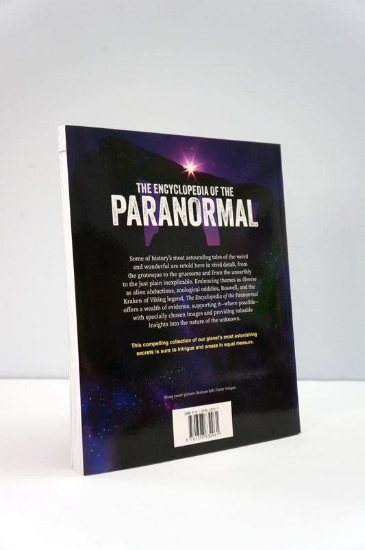 Book titled 'The Encyclopedia of the Paranormal' on a white background