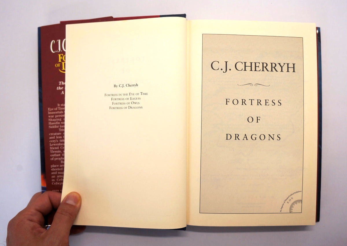 An open copy of the book 'Fortress of Dragons' by C.J.