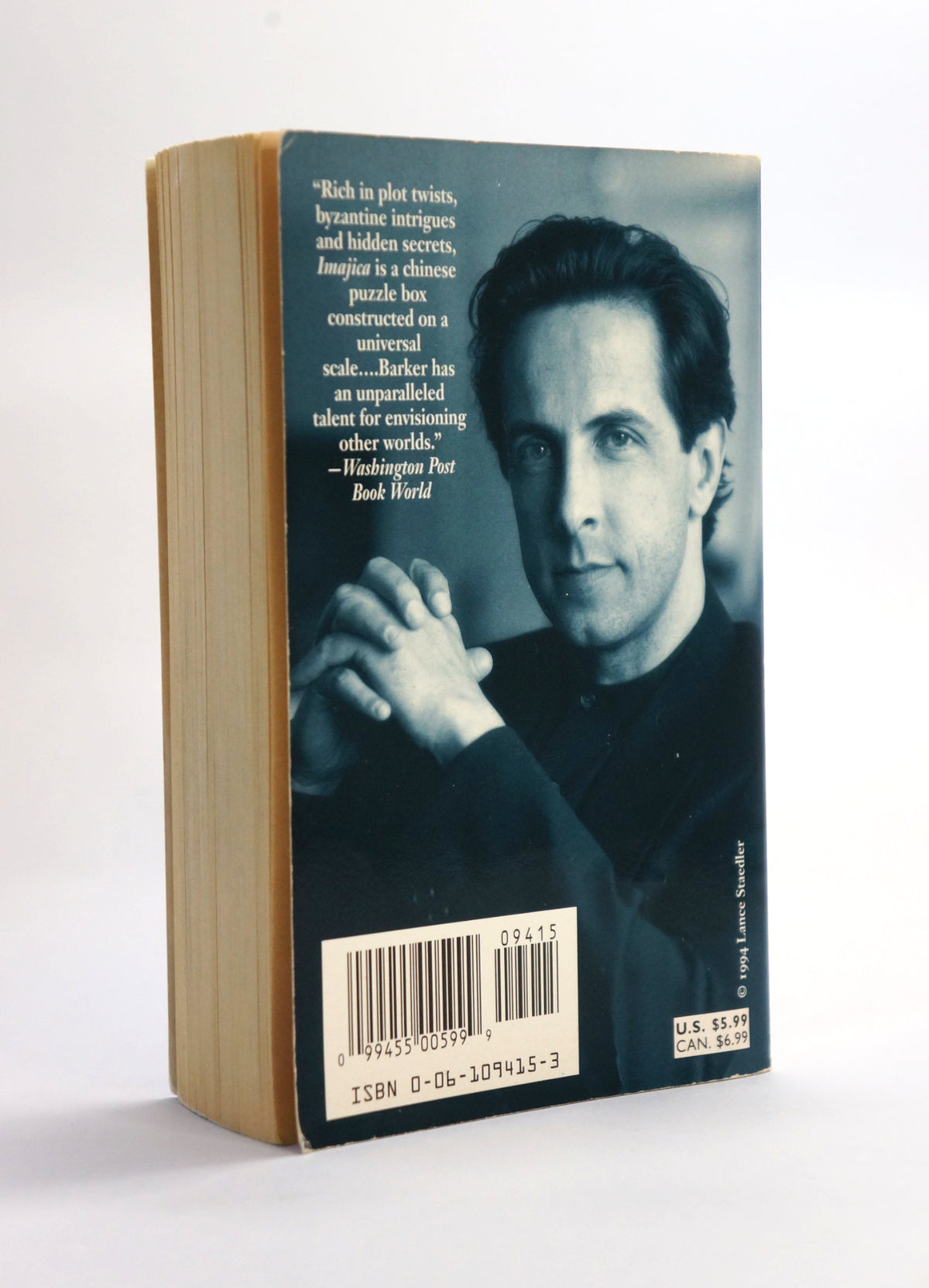 A paperback book of Clive Barker's 'Imajica Book II: The Reconciliation' standing upright on a white background. Back cover