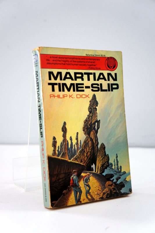 Book titled 'Martian Time-Slip' by Philip K. Dick on a white background
