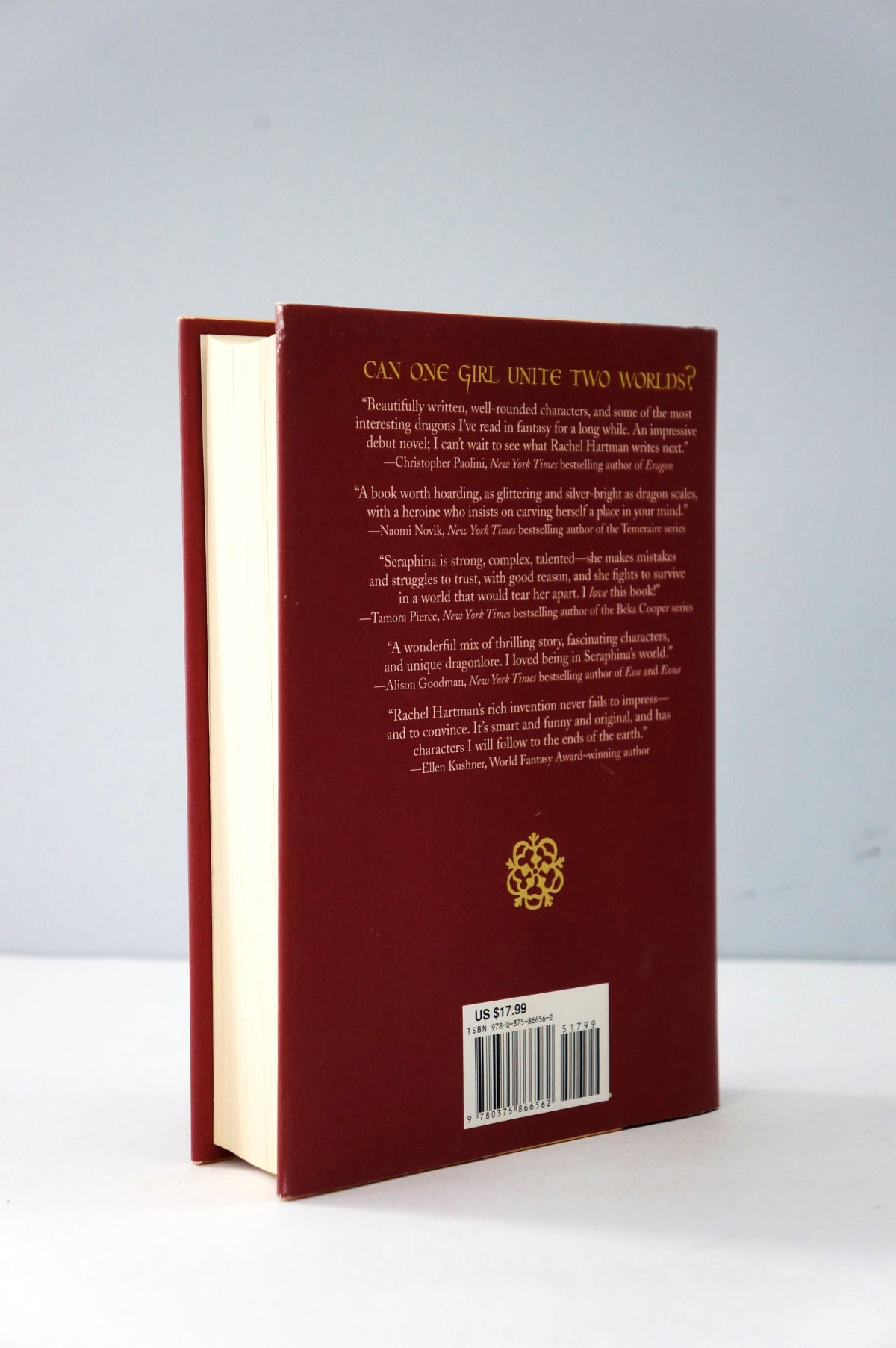 Red book with gold text and design on a white background