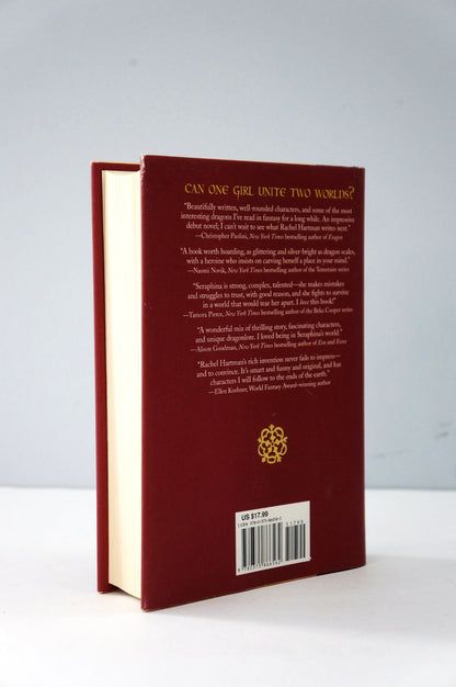 Red book with gold text and design on a white background