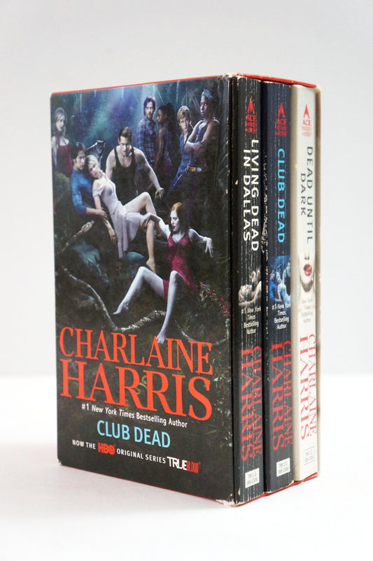 A boxed set of three books by Charlaine Harris titled Club Dead, shown standing upright against a plain light background. The front cover features a dark illustrated scene with several people, and the spines are visible behind it.