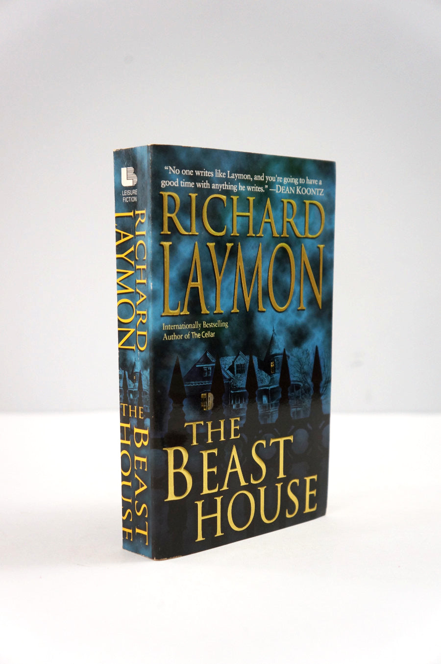 Book titled 'The Beast House' by Richard Laymon on a white background