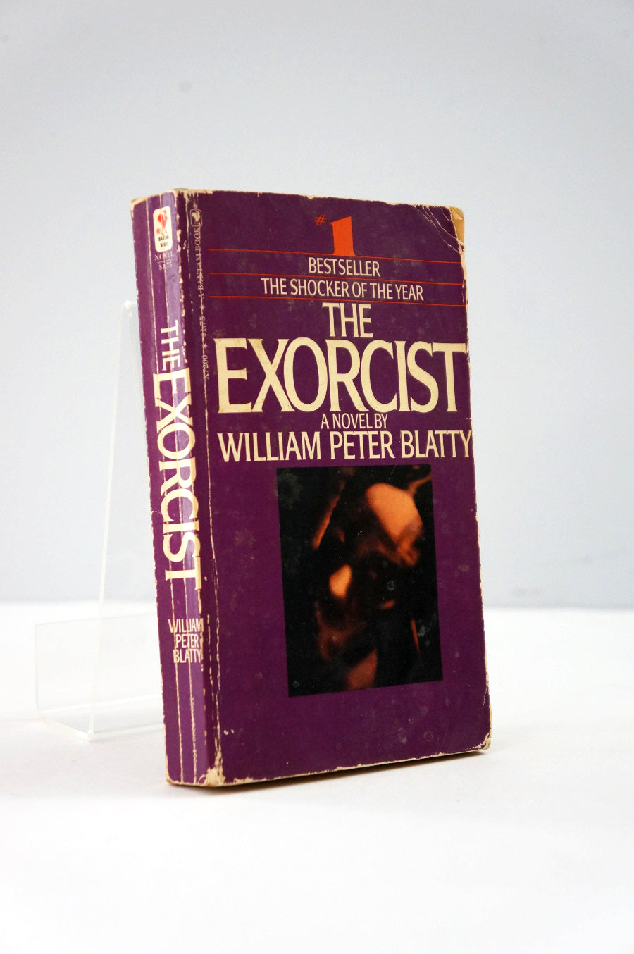 Book titled 'The Exorcist' by William Peter Blatty on a white background