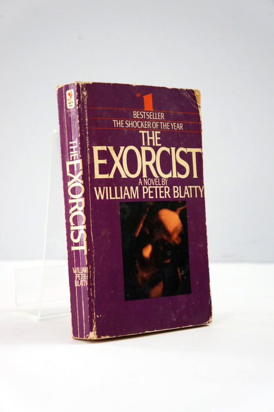 Book titled 'The Exorcist' by William Peter Blatty on a white background