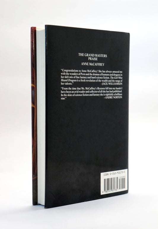 The back cover of a hardcover book, showing the title by Anne McCaffrey, white text on a black cover, a brown spine edge, and a barcode label at the bottom right.