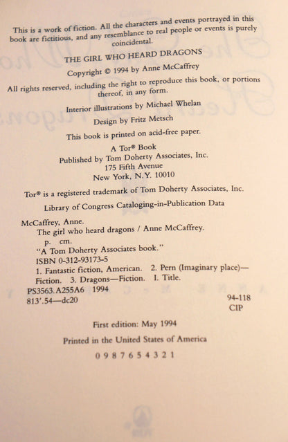 A photographed book interior page showing printed copyright and publication information for 'The Girl Who Heard Dragons' by Anne McCaffrey, including publisher text, ISBN, and printing details on an off-white page.