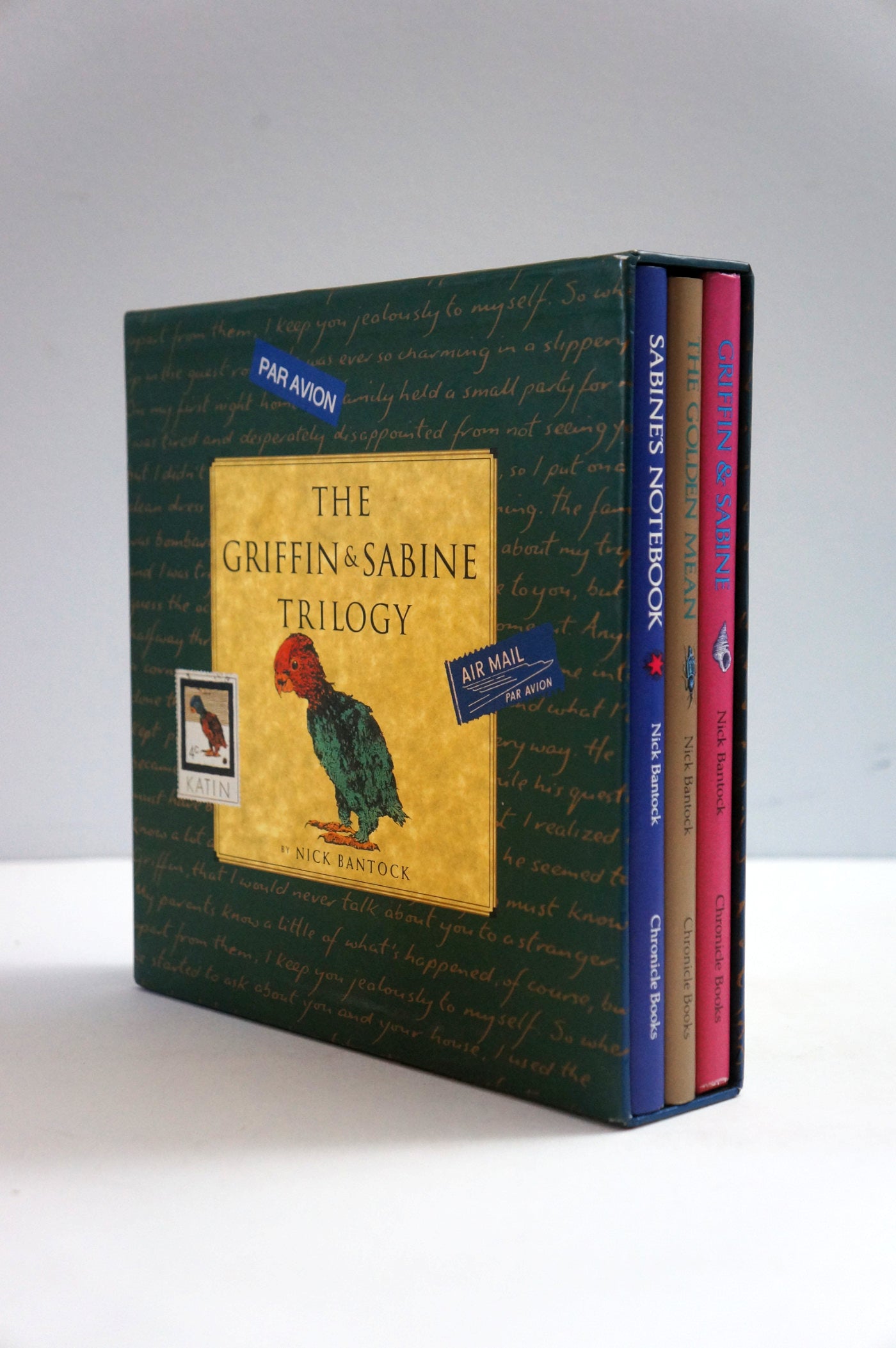 The Griffin and Sabine Trilogy book box set by Mark Twain, featuring a dark green slipcase with a gold label and three books visible on the right side against a plain light gray background.