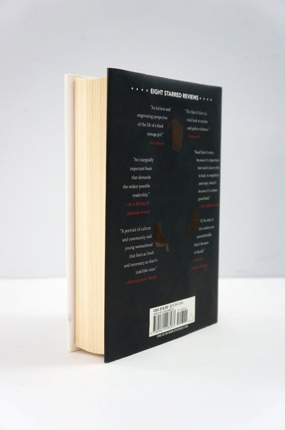 Book with a black cover and beige pages on a white background