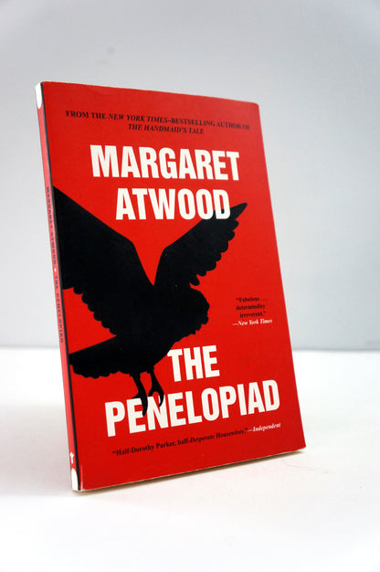 Book titled 'The Penelopiad' by Margaret Atwood with a red cover and black silhouette of a bird.