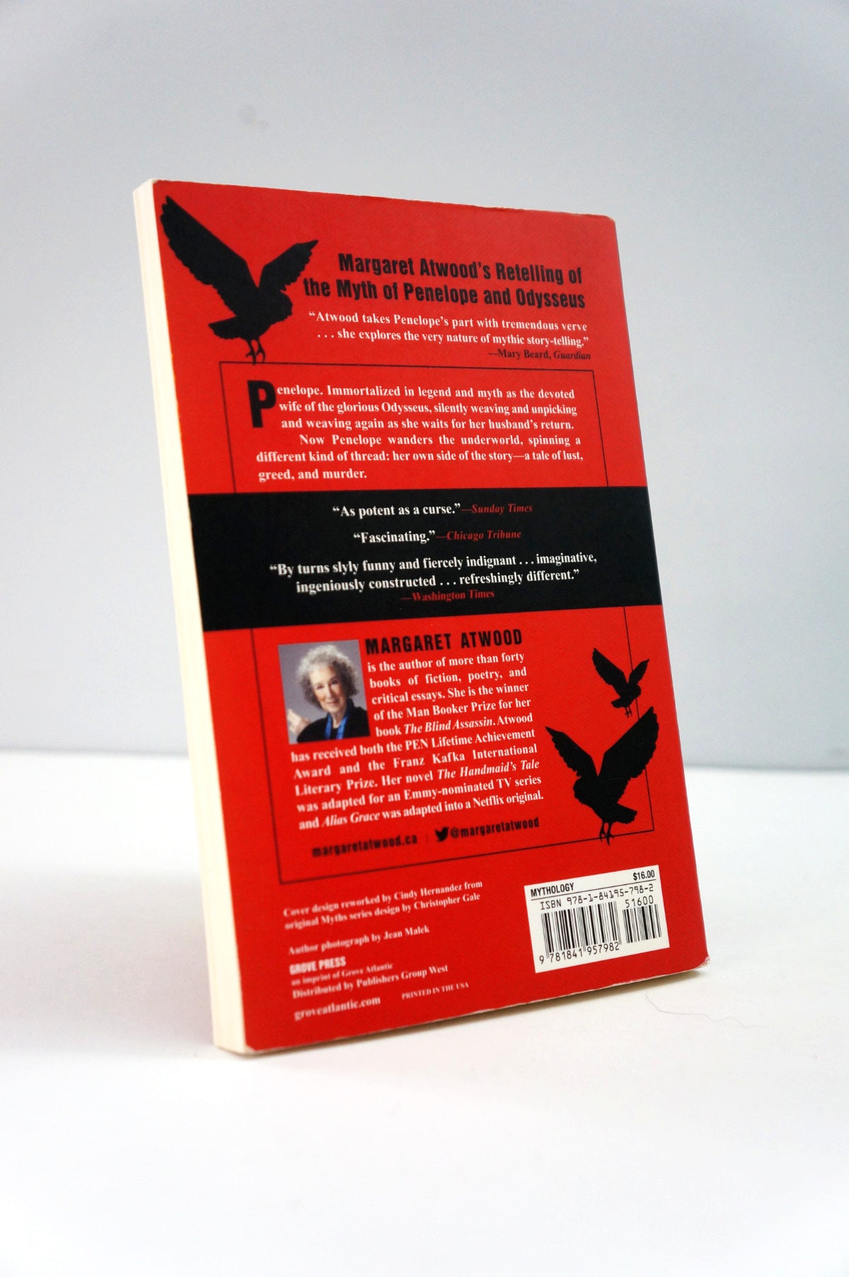 Book cover with red and black design featuring text and images of a woman and birds on a white background.