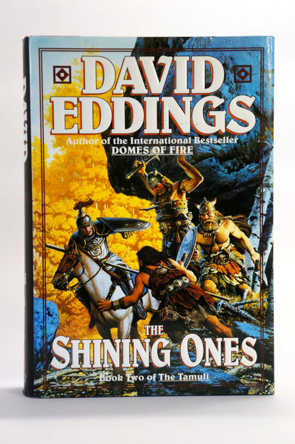 A vintage hardcover book of David Eddings' 'The Shining Ones' (Book Two of The Tamul) standing upright against a plain white background.