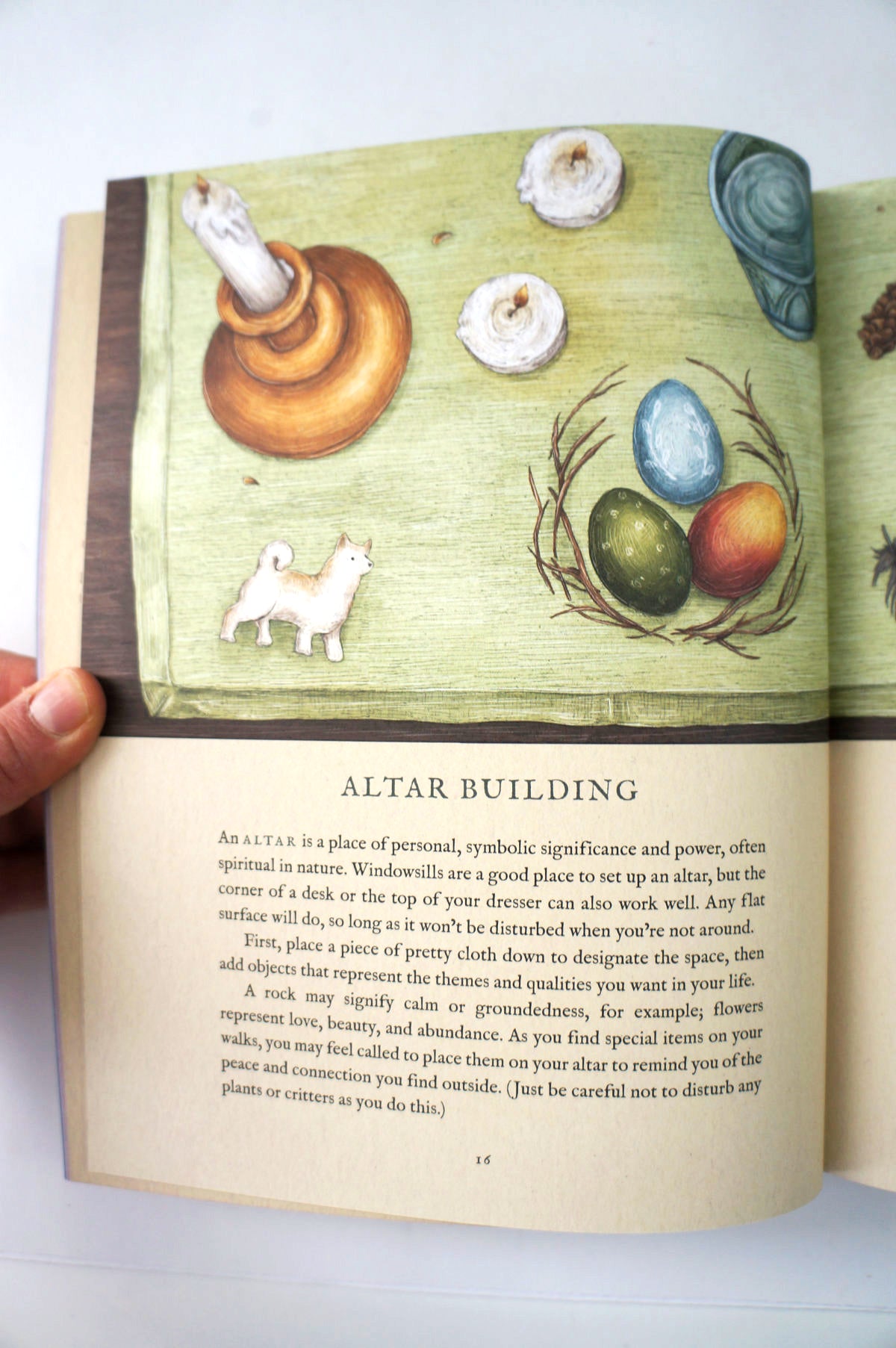 Open book with illustrations of a candle, oil lamp, eggs in an nest, and a dog, with text about altar building.