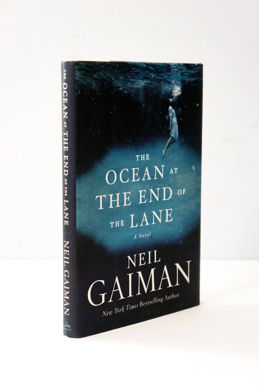 Book titled 'The Ocean at the End of the Lane' by Neil Gaiman on a white background