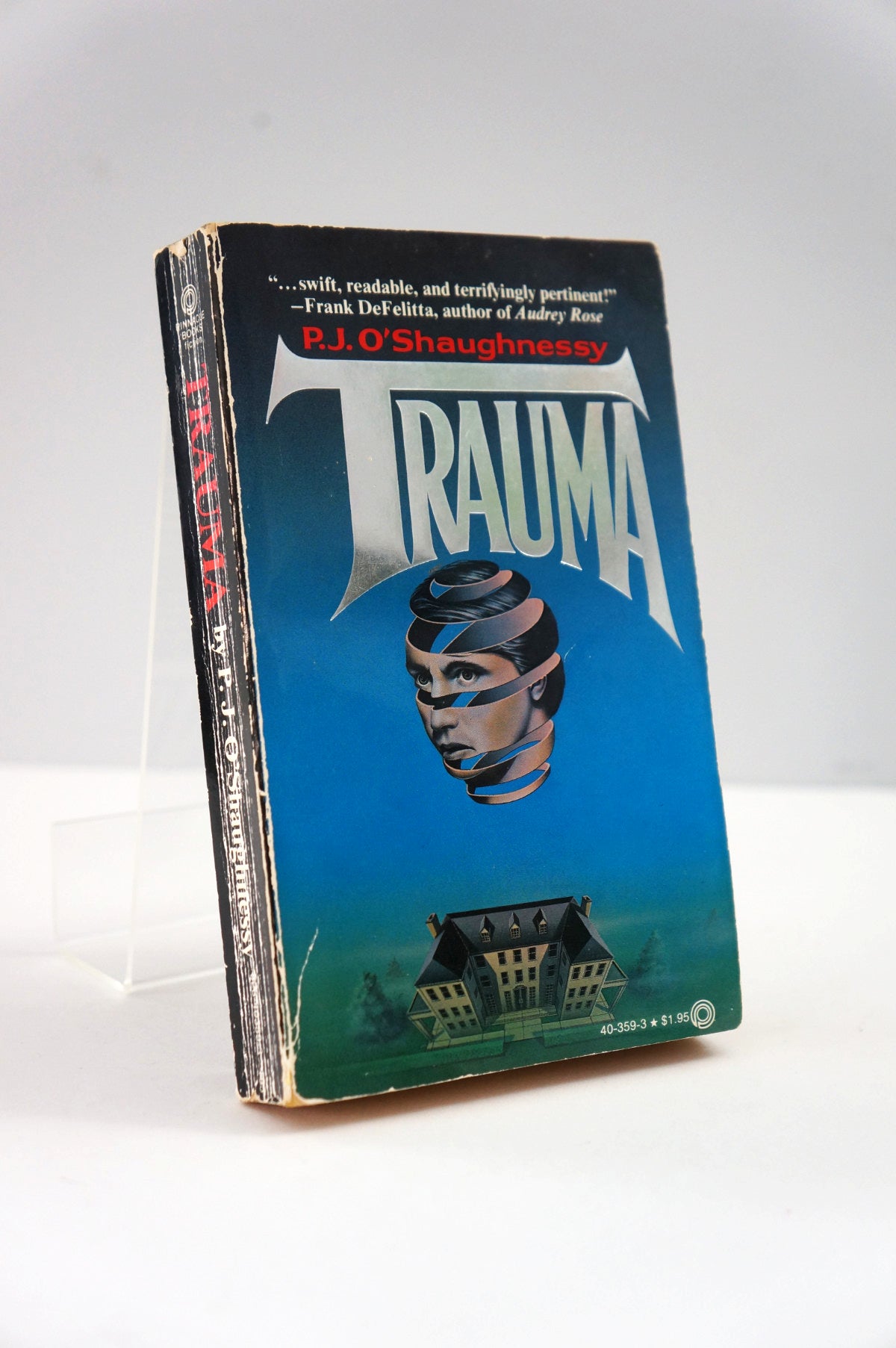 Book titled 'Trauma' by P.J. O'Shaughnessy on a white background