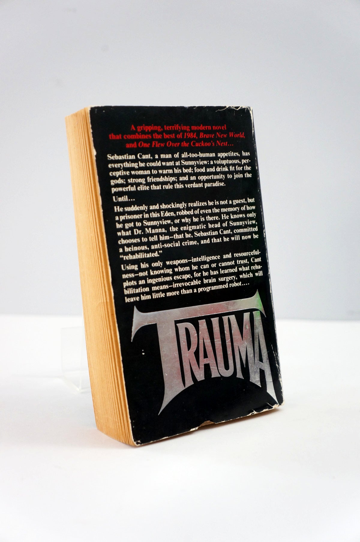 Book titled 'Trauma' with a black cover and visible text on a white background