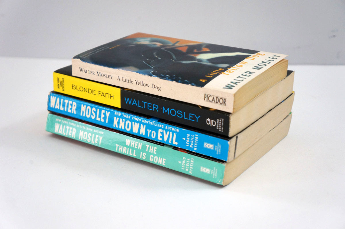 Stack of books by Walter Mosley on a white surface