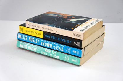 Stack of books by Walter Mosley on a white surface