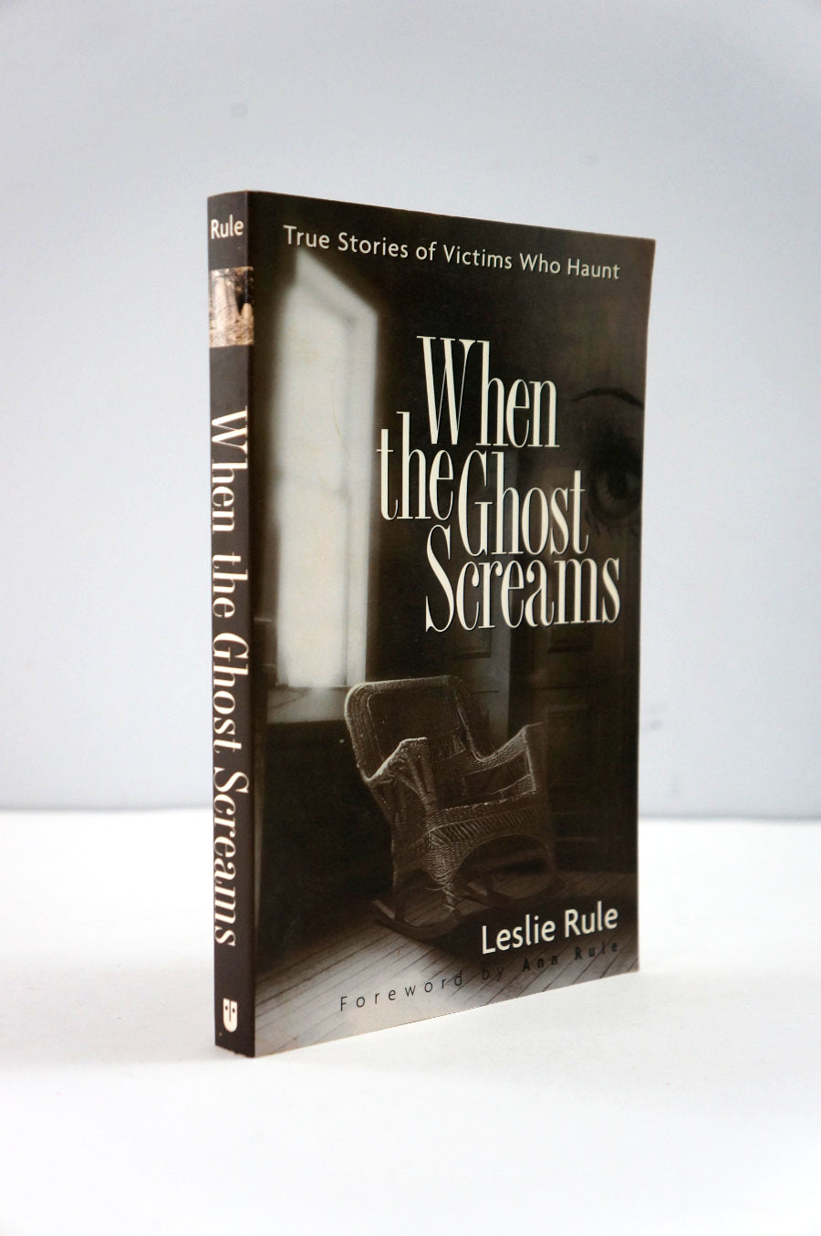 Book titled 'When the Ghost Screams' by Leslie Rule on a white background
