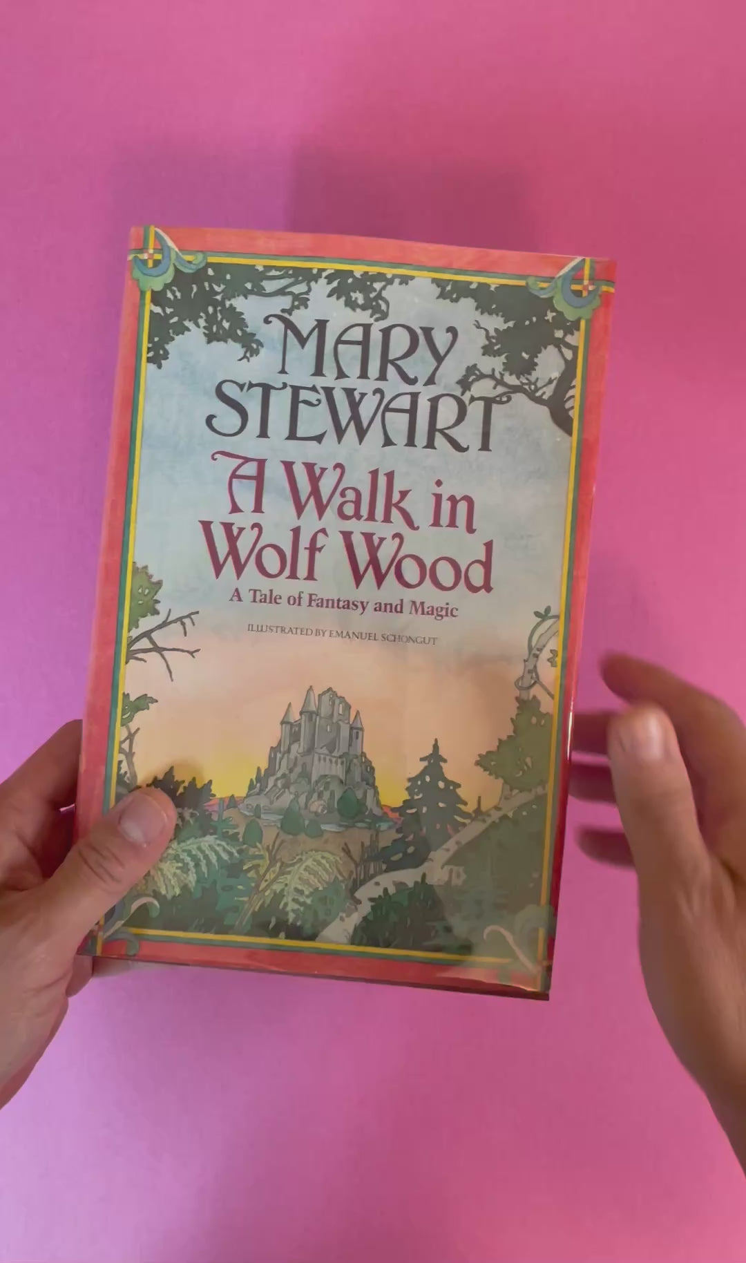 Video of a hardcover copy of A Walk in Wolf Wood by Mary Stewart featuring a painted fantasy scene with a castle on the cover.